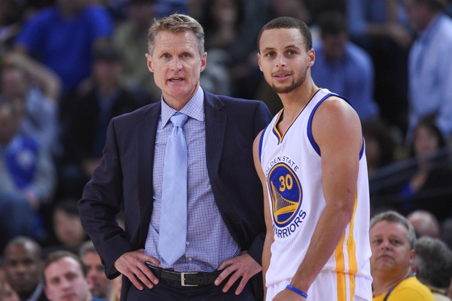 December 2, 2014; Oakland, CA, USA; Golden State Warriors head coach Steve Kerr (left) talks to guard Stephen Curry (30) during the fourth quarter against the Orlando Magic at Oracle Arena. The Warriors defeated the Magic 98-97. Mandatory Credit: Kyle Terada-USA TODAY Sports