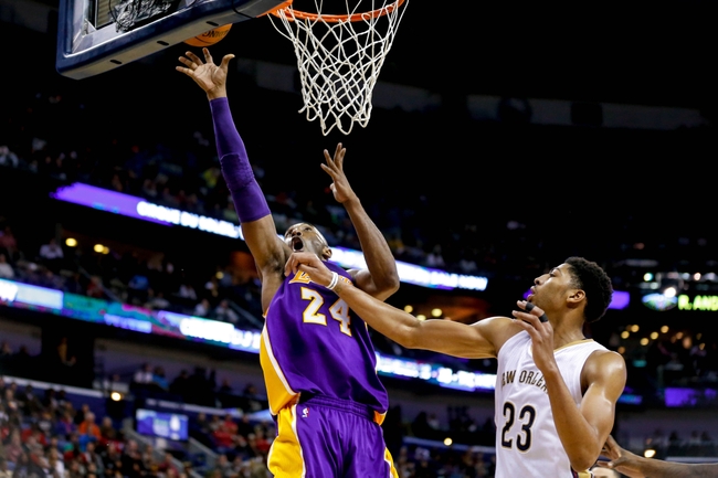 Nov 12, 2014; New Orleans, LA, USA; Los Angeles Lakers guard Kobe Bryant (24) shoots over New Orleans Pelicans forward Anthony Davis (23) during  a game at the Smoothie King Center. The Pelicans defeated the Lakers 109-102. Mandatory Credit: Derick E. Hingle-USA TODAY Sports