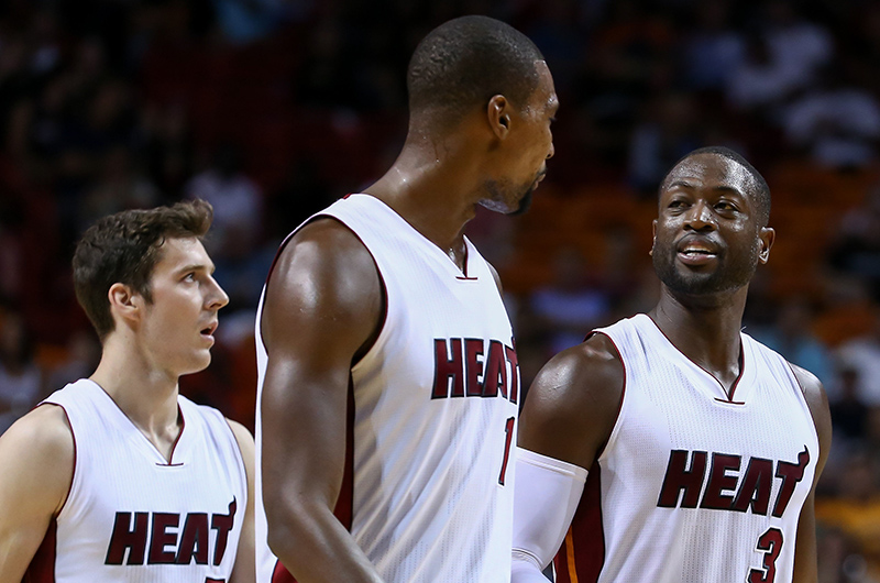 Oct 12, 2015; Miami, FL, USA; Miami Heat guard Dwyane Wade (3) talks with Miami Heat forward Chris Bosh (1) during the second half against the San Antonio Spurs at American Airlines Arena. Mandatory Credit: Steve Mitchell-USA TODAY Sports