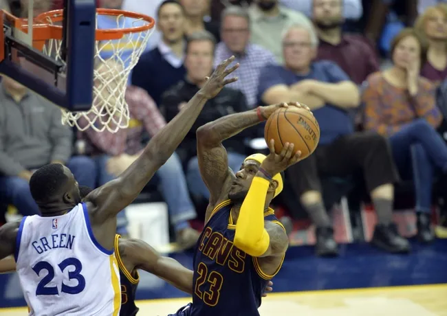 Feb 26, 2015; Cleveland, OH, USA; Cleveland Cavaliers forward LeBron James (23) drives against Golden State Warriors forward Draymond Green (23) in the fourth quarter at Quicken Loans Arena. Mandatory Credit: David Richard-USA TODAY Sports