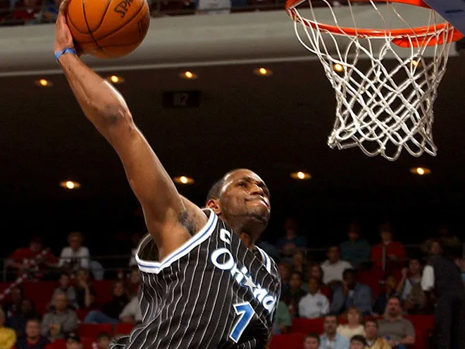 Orlando Magic's Tracy McGrady slams in a one-handed dunk during the first half against the Cleveland Cavaliers in Orlando, Fla., Thursday, Dec. 25, 2003. McGrady scored 41 points to lead the Magic to a 113-101 overtime win. (AP Photo/The Orlando Sentinel, Gary W. Green) ORG XMIT: FLORL102