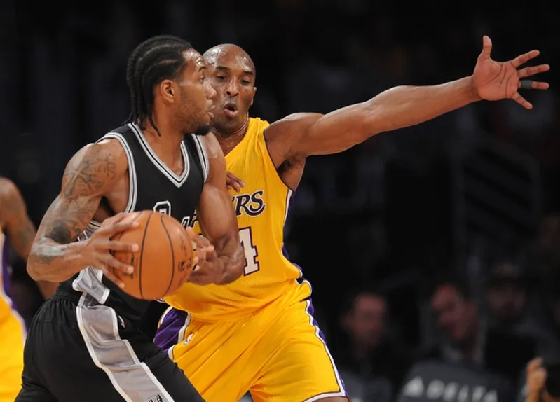 January 22, 2016; Los Angeles, CA, USA; San Antonio Spurs forward Kawhi Leonard (2) controls the ball against Los Angeles Lakers forward Kobe Bryant (24) during the first half at Staples Center. Mandatory Credit: Gary A. Vasquez-USA TODAY Sports