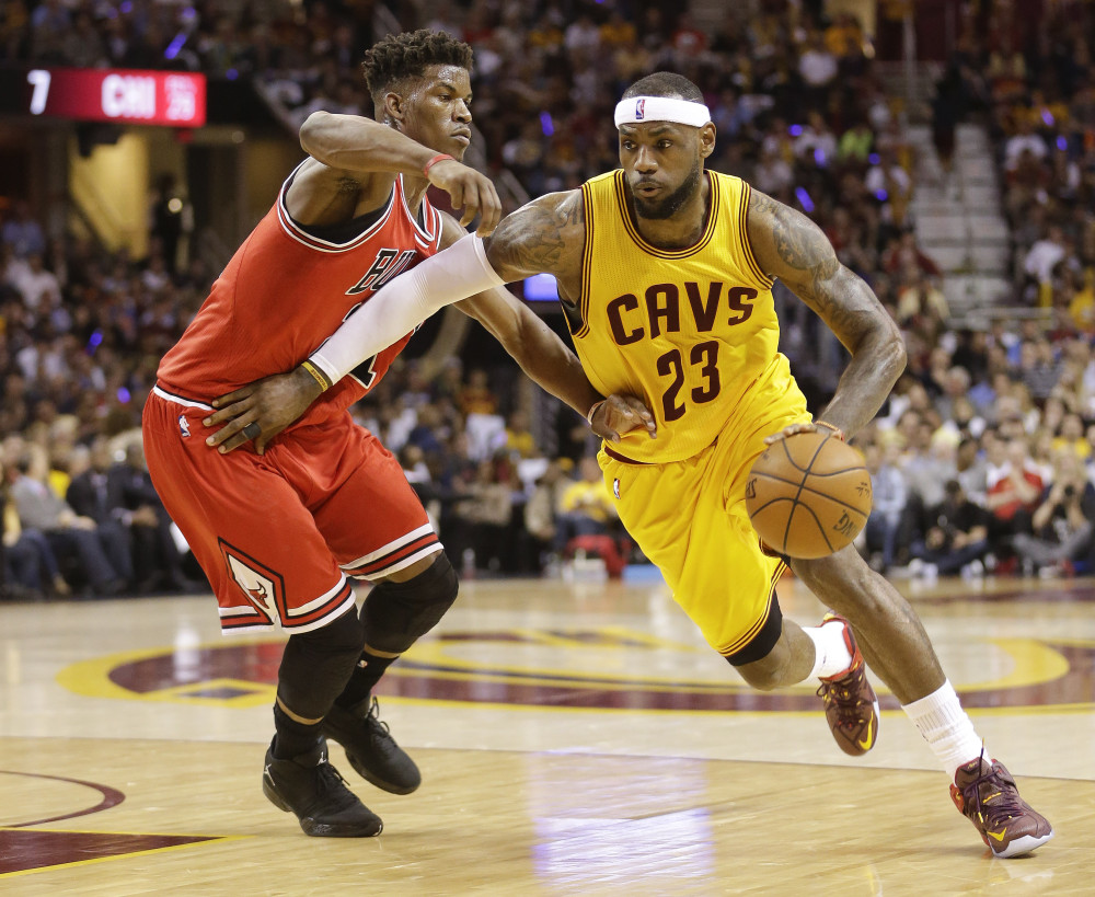 Cleveland Cavaliers forward LeBron James (23) drives against Chicago Bulls guard Jimmy Butler (21) during the first half of Game 2 in a second-round NBA basketball playoff series Wednesday, May 6, 2015, in Cleveland. (AP Photo/Tony Dejak) ORG XMIT: OHJJ119