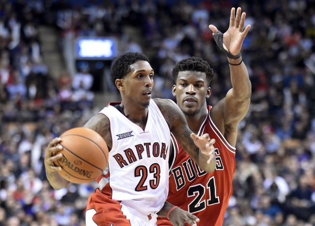 Nov 13, 2014; Toronto, Ontario, CAN;  Toronto Raptors guard Louis Williams (23) dribbles past Chicago Bulls guard Jimmy Butler (21) during the fourth quarter at Air Canada Centre. Chicago won 100 - 93. Mandatory Credit: Peter Llewellyn-USA TODAY Sports